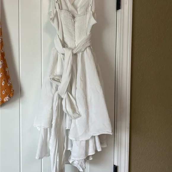 Purchased at Blu Spero, white romper with tie in the back bow. - Picture 3 of 3